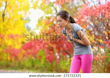 Running nausea - nauseous and sick ill runner vomiting. Running woman feeling bad about to throw up. Girl having nausea from dehydration or chest pain.