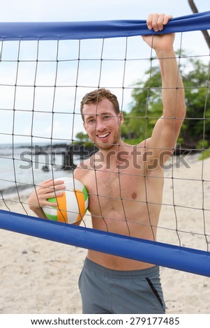 Beach volleyball man in sporty active lifestyle portrait holding volley ball after game on summer beach. Handsome topless shirtless male fitness model living healthy lifestyle doing sport on beach.