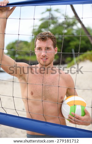 Beach volleyball man in sporty healthy lifestyle portrait holding volley ball after game on summer beach. Handsome topless shirtless male fitness model living active lifestyle doing sport on beach.