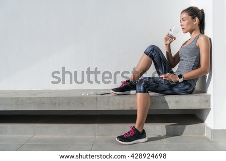 Fitness athlete woman drinking water during cardio workout break Healthy living hydration concept. Runner woman preventing dehydration for her health and body by hydrating on summer outdoors training.
