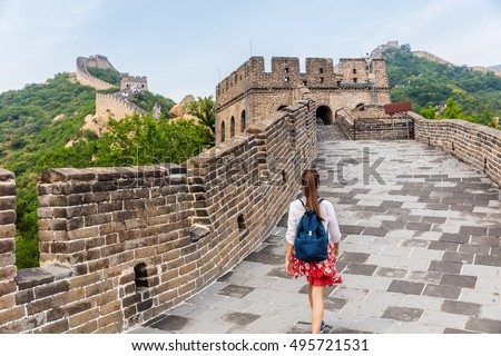 Great Wall of China. Tourist on Asia travel walking on famous Chinese tourist destination and attraction in Badaling north of Beijing. Woman traveler hiking great wall enjoying her summer vacation.