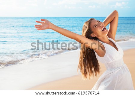 Freedom woman on beach enjoying life with open arms feeling free bliss and success on beach. Happiness Asian girl in white summer dress enjoying ocean nature sunset during travel holidays vacation.