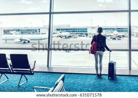 Travel business woman standing with luggage at airport