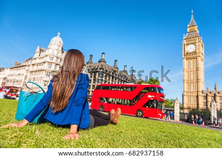 London city lifestyle woman relaxing in Westminster summer park, red bus and big ben tower. Urban girl outdoors.
