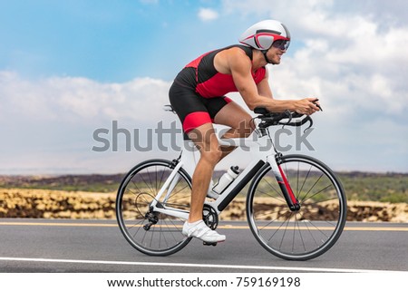 Triathlon cyclist man cycling racing on road bike on ironman competition racing against time. Triathlete training bicycle workout for triathlon race.