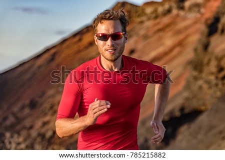 Athlete runner trail running in mountains nature. Sport active fitness ultra trail, run marathoner training outdoor in summer outdoors. Man with sunglasses.