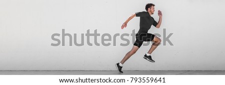 Running man runner training doing outdoor city run sprinting along wall background. Urban healthy active lifestyle. Male athlete doing sprint hiit high intensity interval training. Banner panorama.