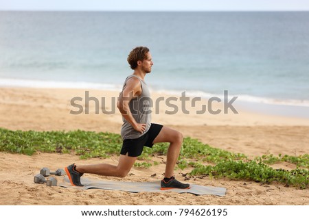 Fitness man doing lunges leg exercise lunge exercising legs. Male fitness model doing alternating bodyweight Lunge workout training glutes, hamstrings and quadriceps.