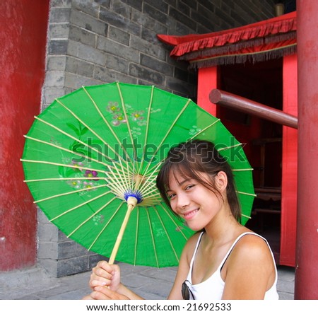 Young asian woman holding a chinese parasol, China