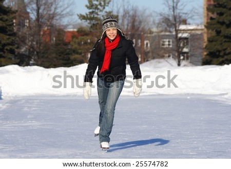 Beautiful young woman skating outdoors in Quebec City