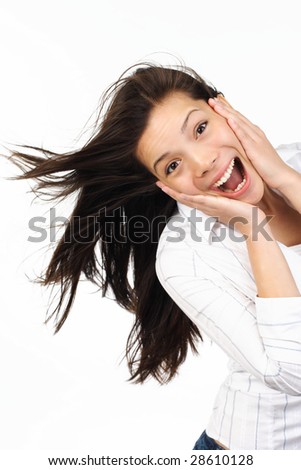 stock photo Very happy and surprised eurasian woman holding her head in 