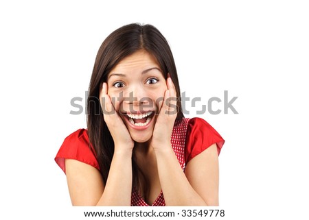 stock photo Very happy and surprised eurasian woman holding her head in 