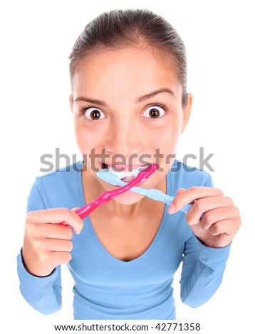 Funny woman with two toothbrushes brushing teeth. Isolated on white background. Concepts could be: 1) Being too busy. 2) Being obsessed with personal hygiene. 3) ?