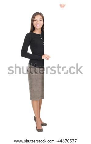 Billboard sign businesswoman. Full length portrait of casual young businesswoman standing with blank white billboard paper sign. Mixed race chinese / caucasian model isolated on white background.