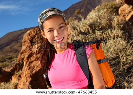Woman hiking closeup. Young asian female model hiking / backpacking in beautiful volcanic landscape on the volcano, Teide, Tenerife, Spain.