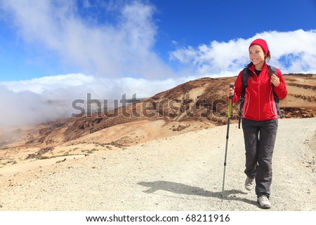 Hiking.  Woman hiker looking at view / copy space in beautiful scenic landscape on volcano Teide, Tenerife, Canary Islands, Spain