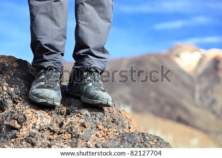 hiking boots / hiking shoes in mountain nature landscape. All year wear. Photo Tenerife, Canary Islands with mountain peak of volcano Teide in the background.