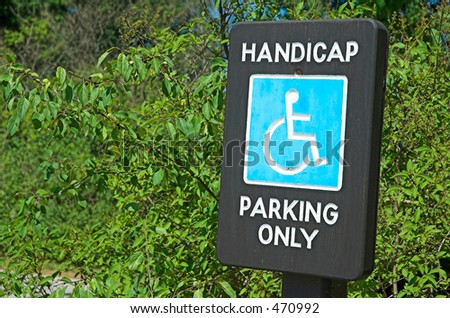 Handicap parking sign carved in wood