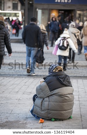 Elder woman begging for money at the street