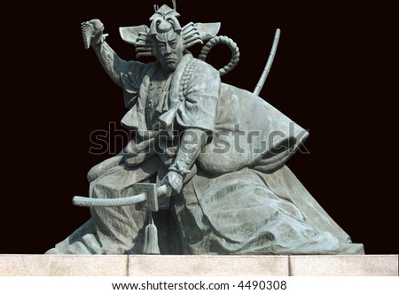 A Samurai warrior statue isolated on a dark background