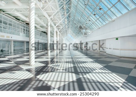An empty airport hallway in bright sunlight