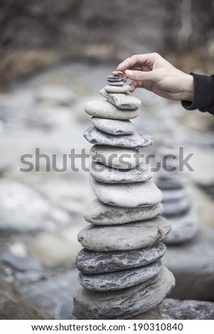 balanced stones stack close up on sea beach