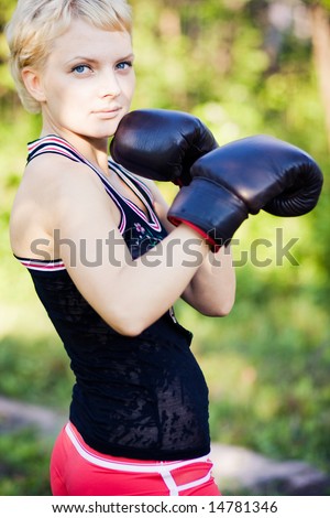 Portrait of young woman boxer outdoor