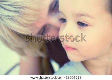 Mam to whisper in son's ear. Focus on child. Special processing