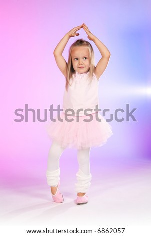 studio shoot of 4 years old girl acting as ballet dancer