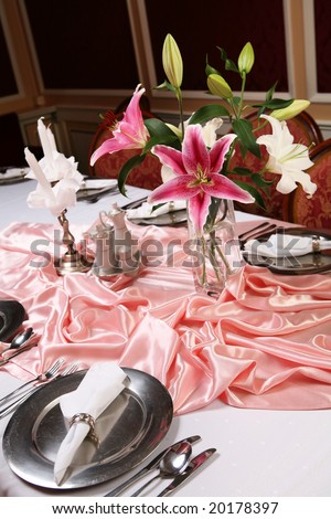 Old style dinning room table set for a formal dinner.
