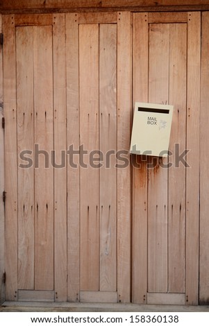 Old wooden planks background and mail box.
