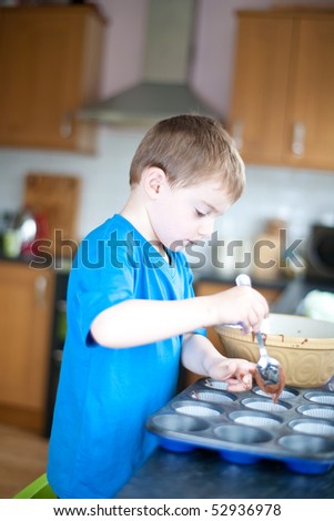 young boy making chocolate cakes