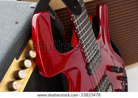 Red electric guitar and two amps