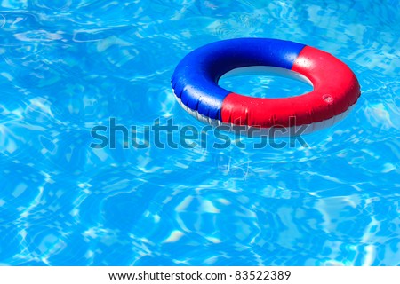 A colorful inflatable ring floating in a blue swimming pool