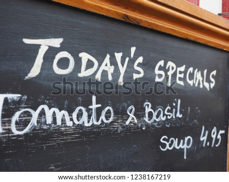 restaurant blackboard with today\'s special tomato and basil soup