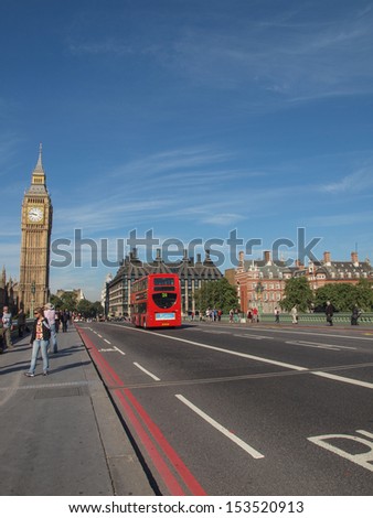LONDON, ENGLAND, UK - SEPTEMBER 8: Tourists and a traditional double decker red bus crossing Westminster Bridge on September 8, 2012 in London, England, UK