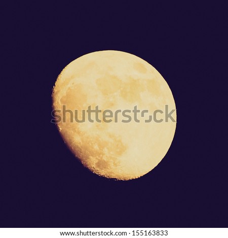 Vintage looking Full moon over dark black sky at night