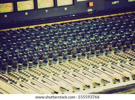 Vintage looking Detail of a soundboard mixer electronic device