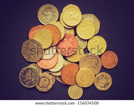 Vintage looking British Pounds coins (UK currency) over a dark background