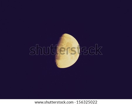 Vintage looking The moon over dark black sky at night