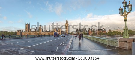 LONDON, ENGLAND, UK - OCTOBER 23: Tourists crossing Westminster Bridge in front of the Houses of Parliament and the Big Ben on October 23, 2013 in London, England, UK