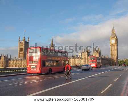 LONDON, ENGLAND, UK - OCTOBER 23: Double decker bus crossing the world famous Westminster Bridge in front of the Houses of Parliament on October 23, 2013 in London, England, UK