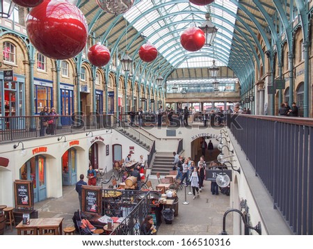 LONDON, ENGLAND, UK - OCTOBER 23: Tourists visiting the world famous Covent Garden on October 23, 2013 in London, England, UK