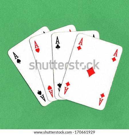 Game of cards with poker of aces over a green game table