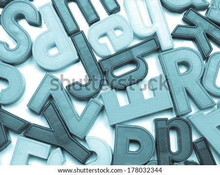English alphabet letters in plastic toy characters - cool cyanotype