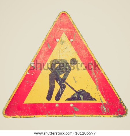 Vintage retro looking Road works sign for construction works in progress - isolated over white background