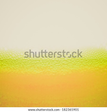 Vintage retro looking Beer foam in a glass, with copy space