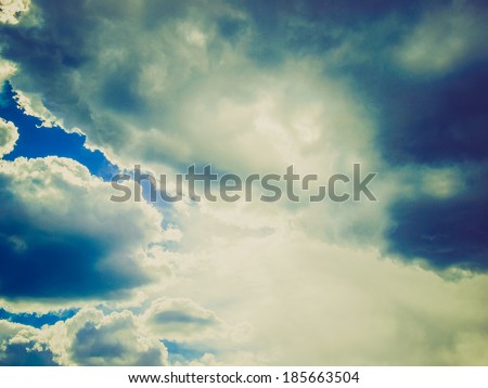 Vintage looking Stormy weather with dark clouds over blue sky