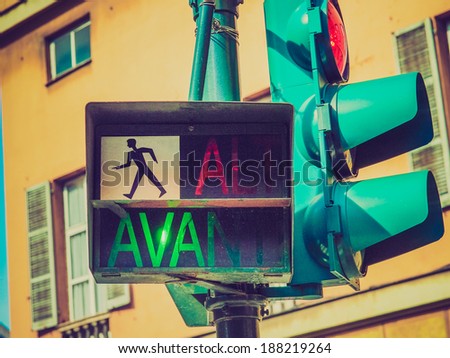 Vintage looking Traffic light for pedestrian crossing showing Avanti sign in green meaning Walk
