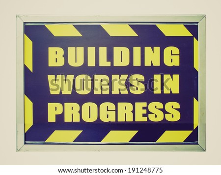 Vintage retro looking Building works in progress sign isolated over white